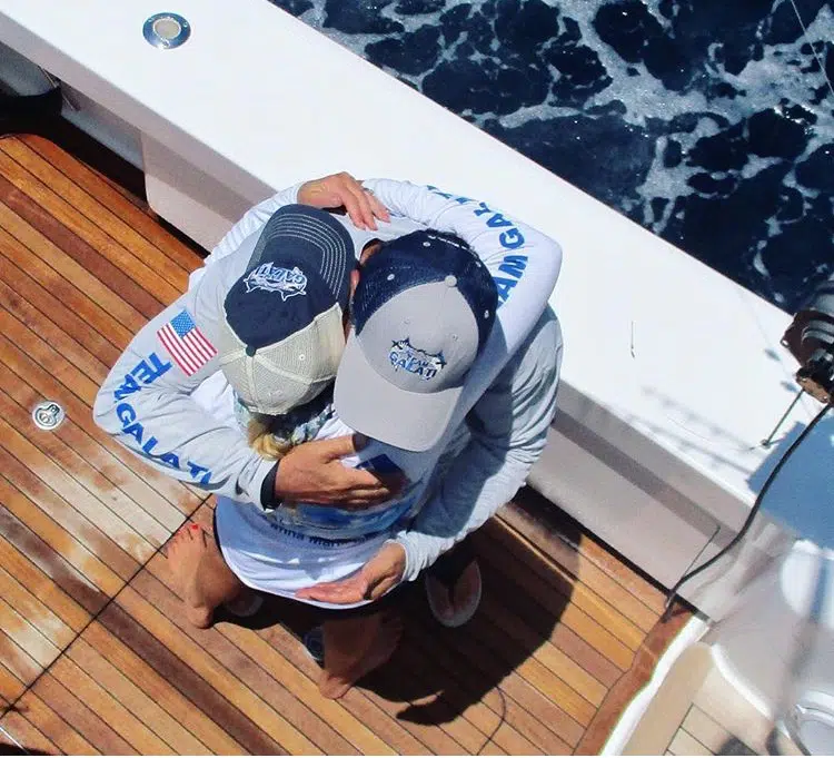 couple hugging aboard yacht